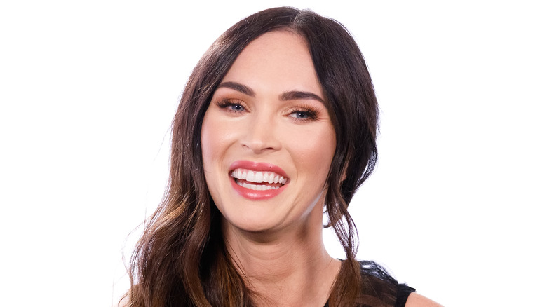 Megan Fox laughing in a studio