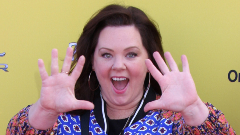 Melissa McCarthy with her hands up