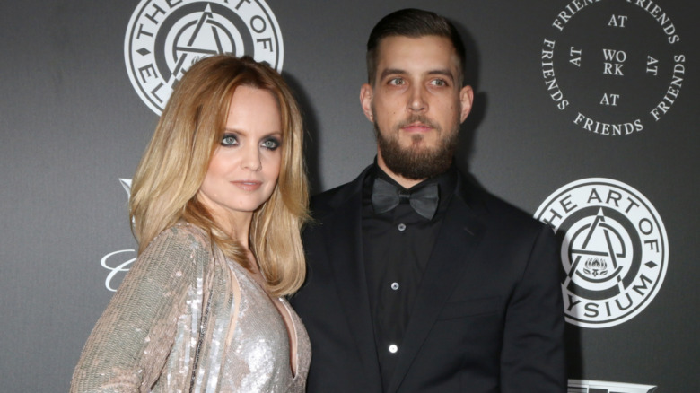 Mena Suvari and husband Michael Hope posing together