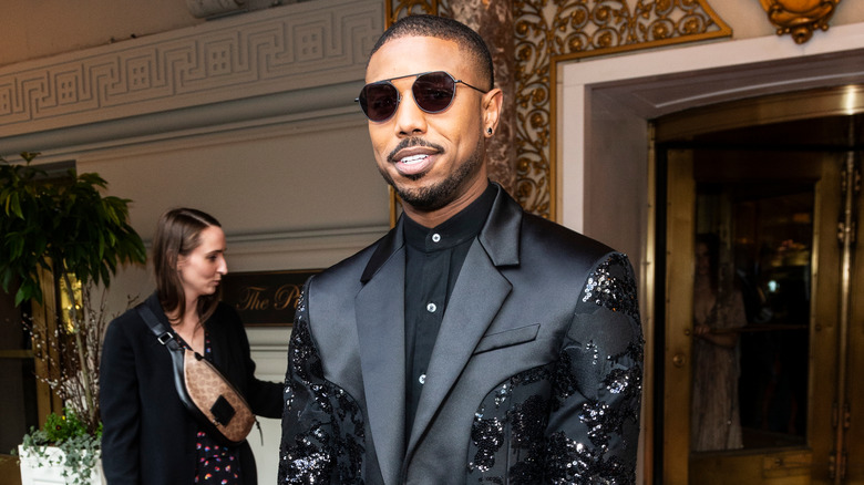 Michael B. Jordan wearing a Coach suit and sunglasses in 2019