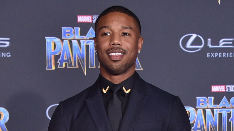 Michael B. Jordan smiling at the 2018 premiere of "The Black Panther"