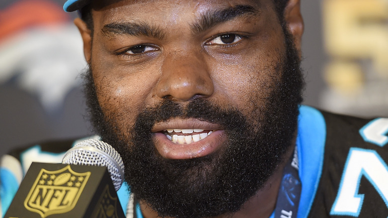 Michael Oher speaking into microphone