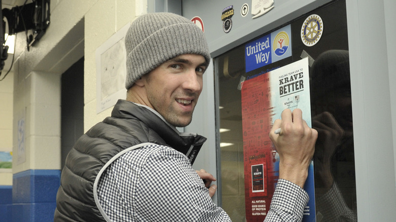 Michael Phelps signing a poster