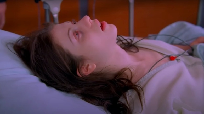 Michelle Trachtenberg in a hospital bed during scene from House