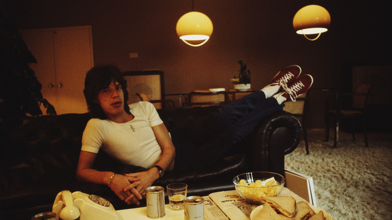 Mick Jagger laying on a sofa