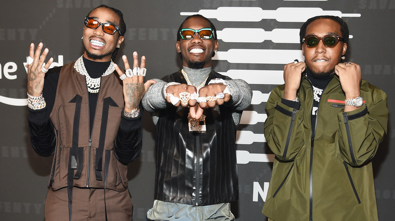 Migos posing at an event