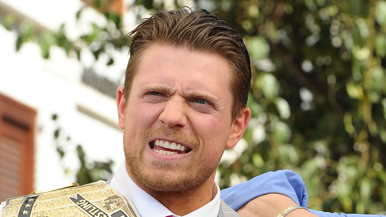 Mike Mizanin holding a belt