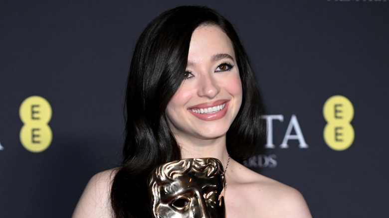 Mikey Madison posing with her BAFTA award for "Anora"