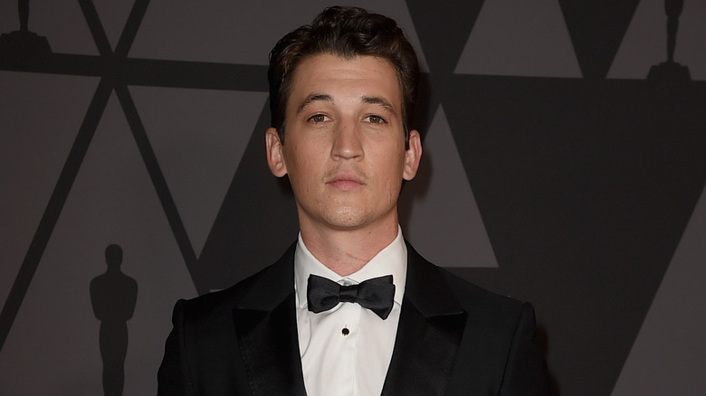 Miles Teller posing in tux