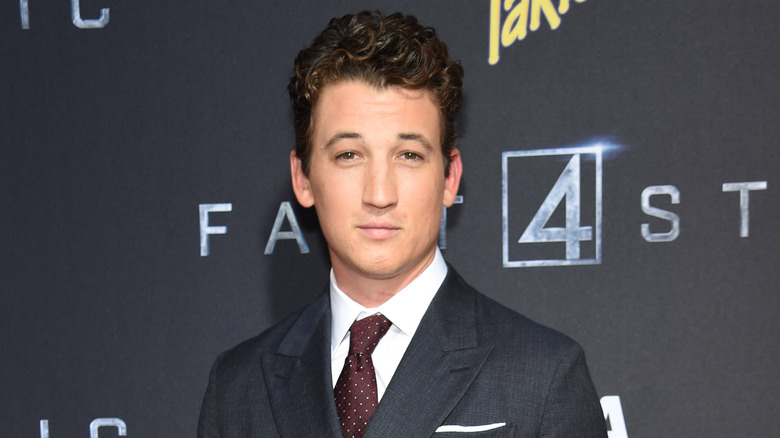 Miles Teller posing in suit