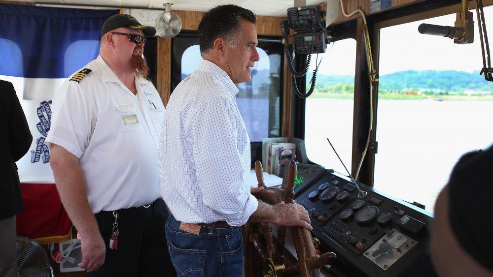 Mitt Romney behind the wheel of a boat 