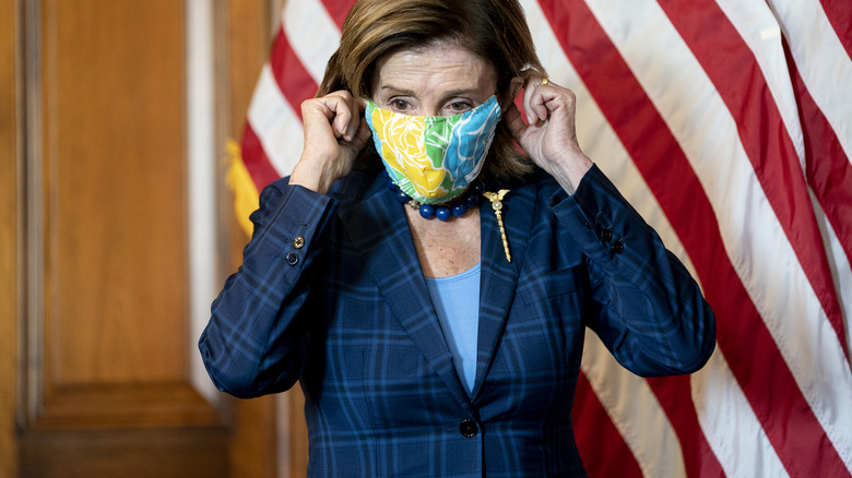 Nancy Pelosi putting on a mask