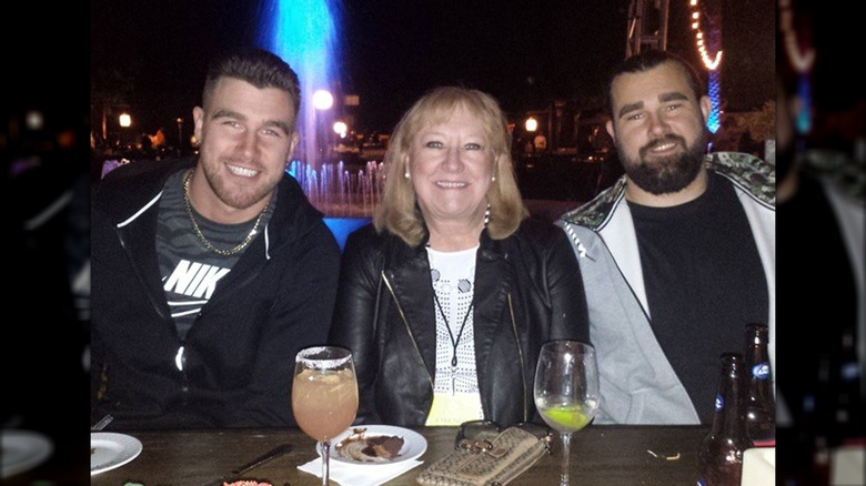 Travis, Donna, and Jason Kelce outdoors at night