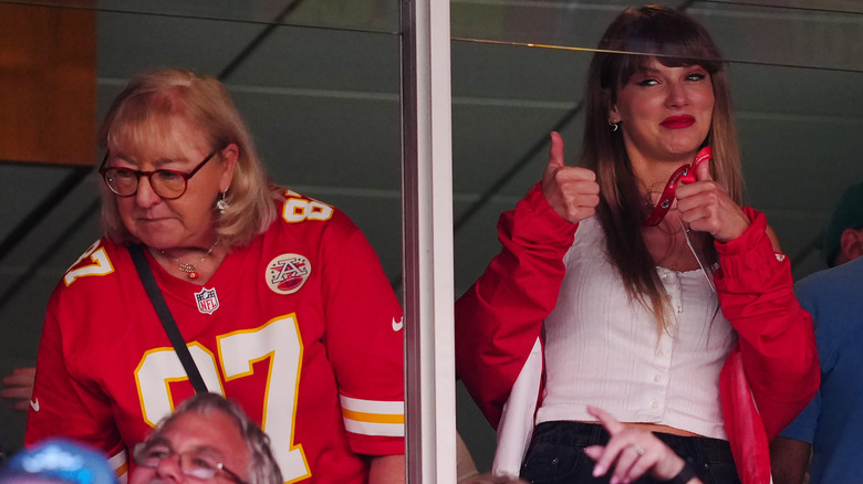 Taylor Swift giving thumbs beside Donna Kelce