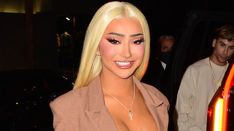 Nikita Dragun smiling for a paparazzo in the street