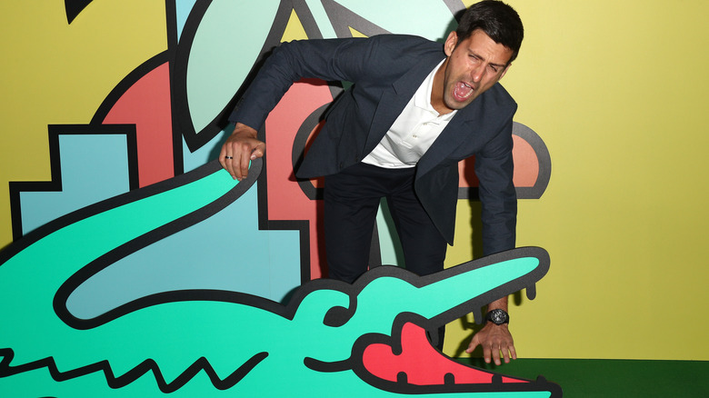 Novak Djokovic with the Lacoste mascot 