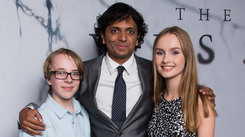 Olivia DeJonge posing with M. Night Shyamalan and Ed Oxenbould