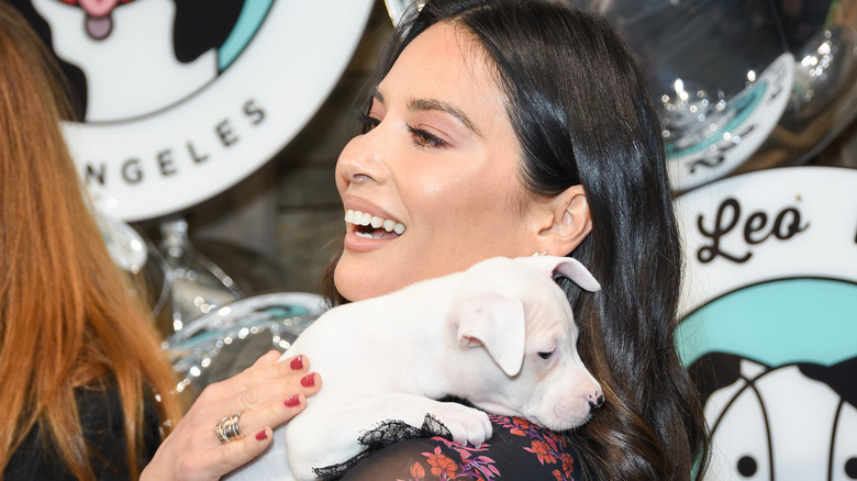 Olivia Munn, holding a puppy