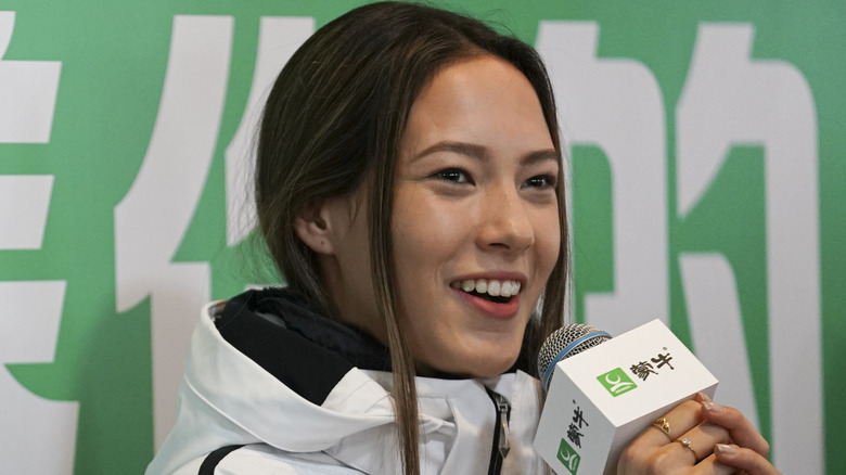 Eileen Gu holding a microphone