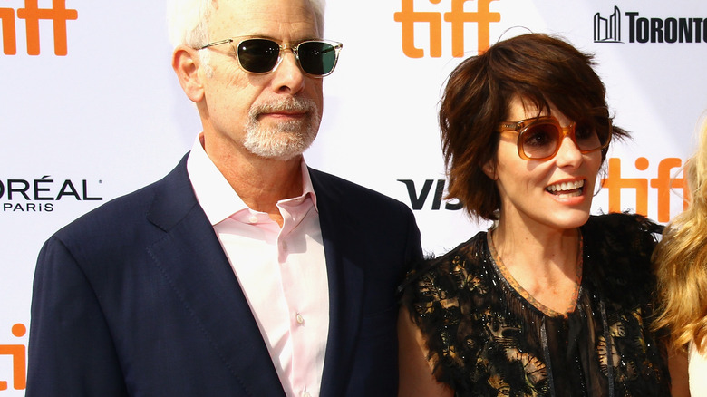 Christopher Guest and Parker Posey pose at event