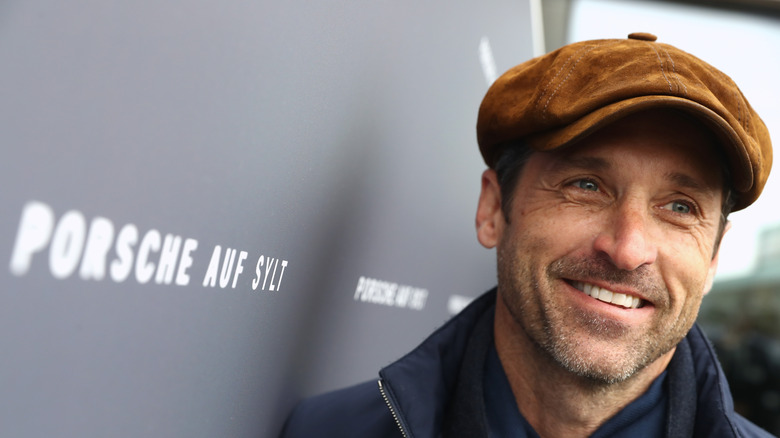 Patrick Dempsey smiling in a pageboy cap