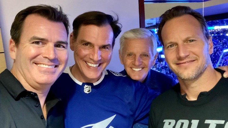 Patrick Wilson smiling with his brothers and father