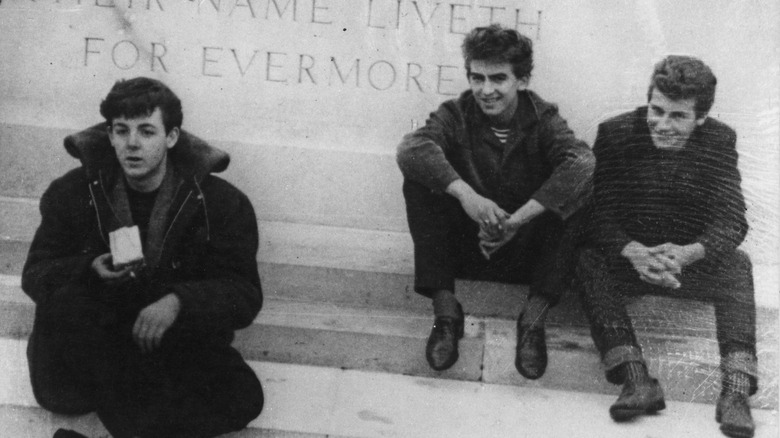 Paul McCartney seated with Pete Best and George Harrison