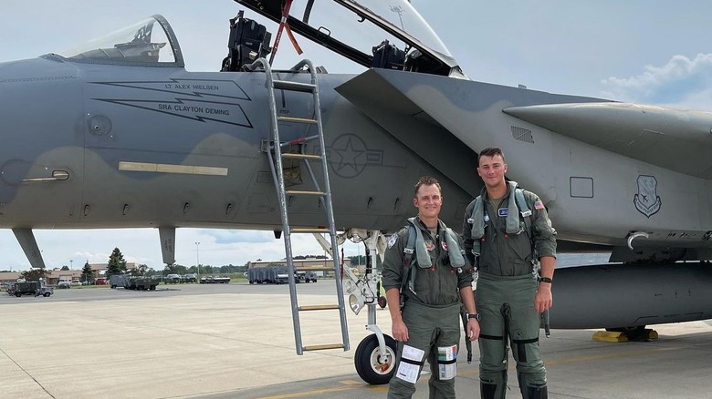 Paul Skenes in front of a fighter jet 