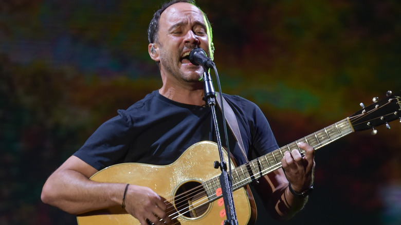 Dave Matthews on stage singing and playing guitar