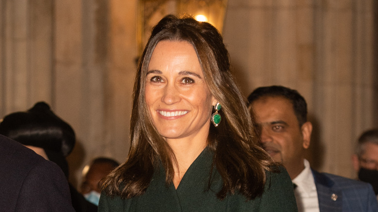 Pippa Middleton in smiling in coat