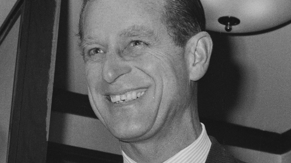 Prince Philip smiling broadly in a black and white photo 