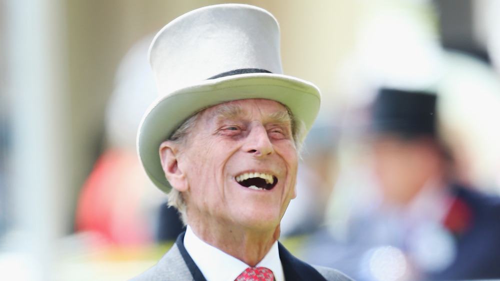 Prince Philip laughing in top hat