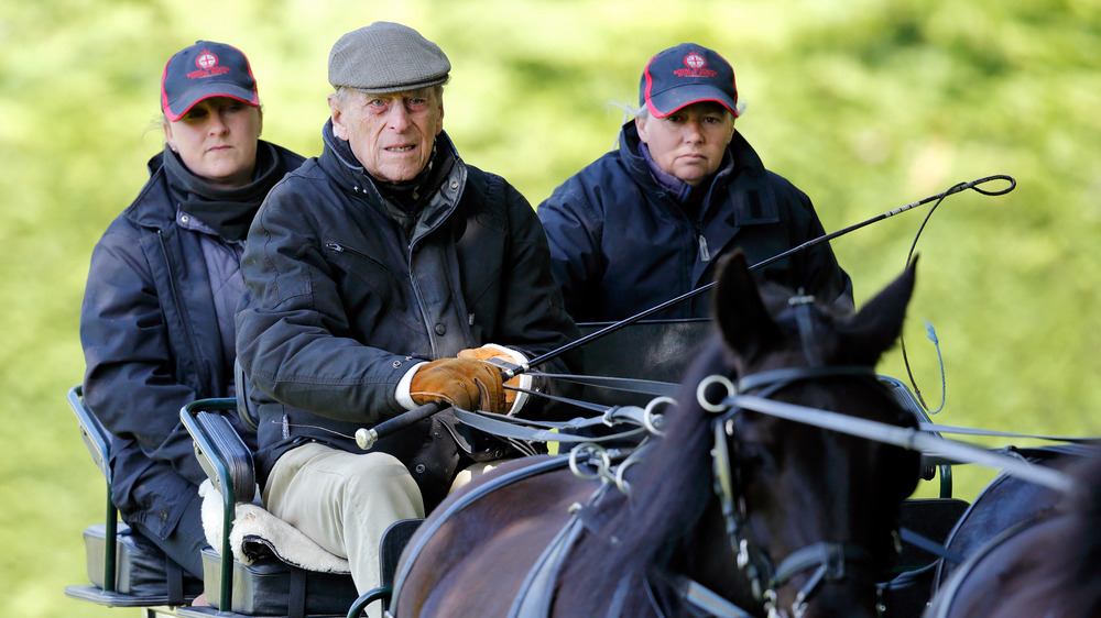 Prince Philip looking irritated during a carriage ride