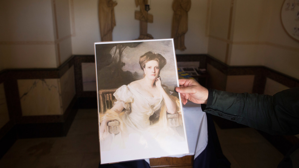 A hand holding a portrait of Princess Alice of Battenberg