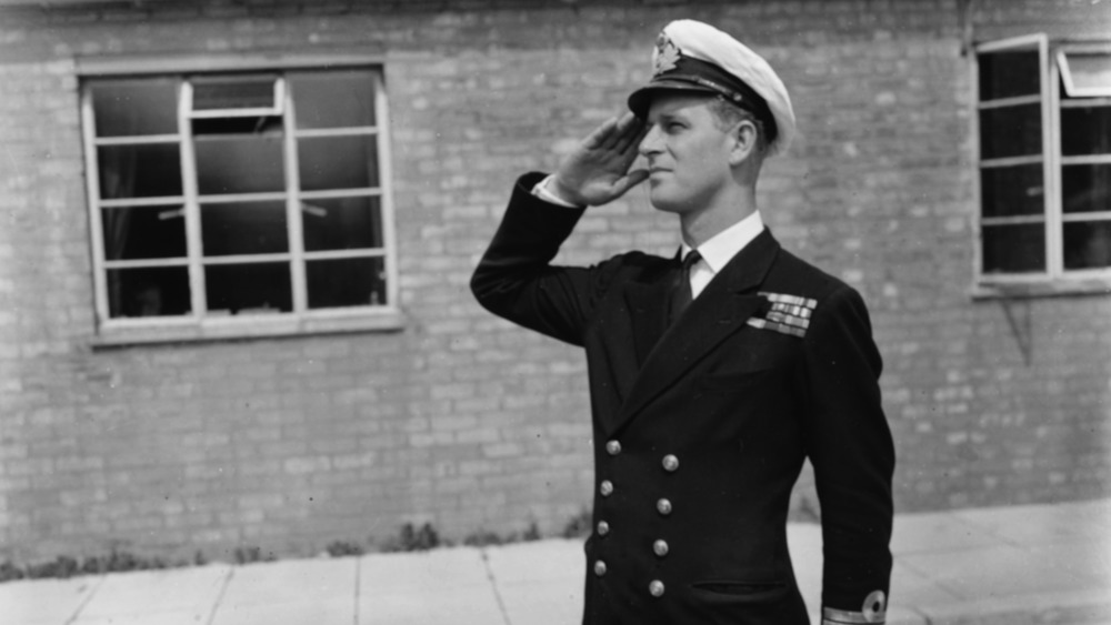 A young Prince Philip saluting in his Navy univorm