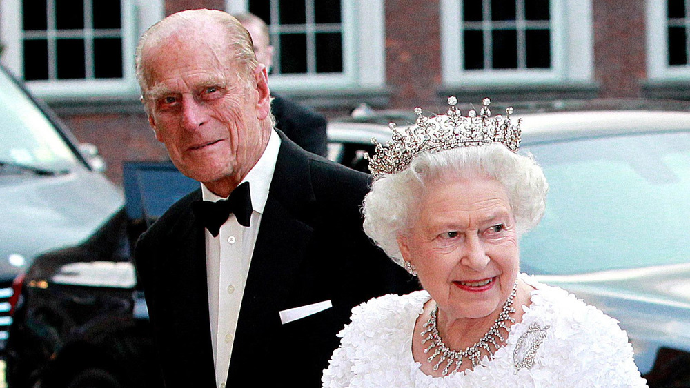 Prince Philip and Queen Elizabeth II smiling while arriving to an event 