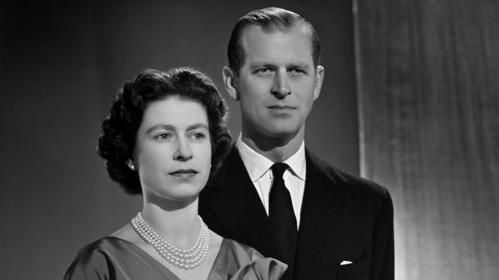 Queen Elizabeth and Prince Philip posing for a black and white portrait