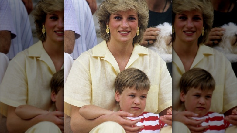 Princess Diana holding Prince William at an event 