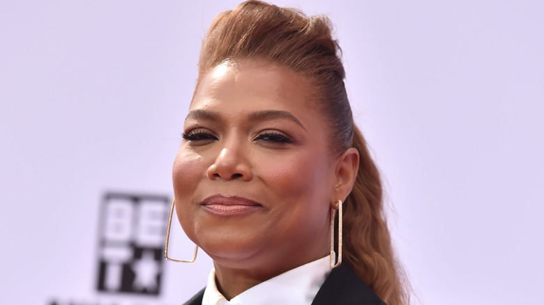 Queen Latifah with a sly smile