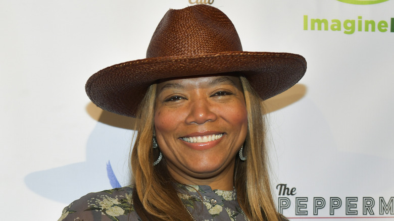 Queen Latifah wearing a brown hat