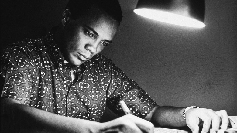 Quincy Jones writing by lamplight