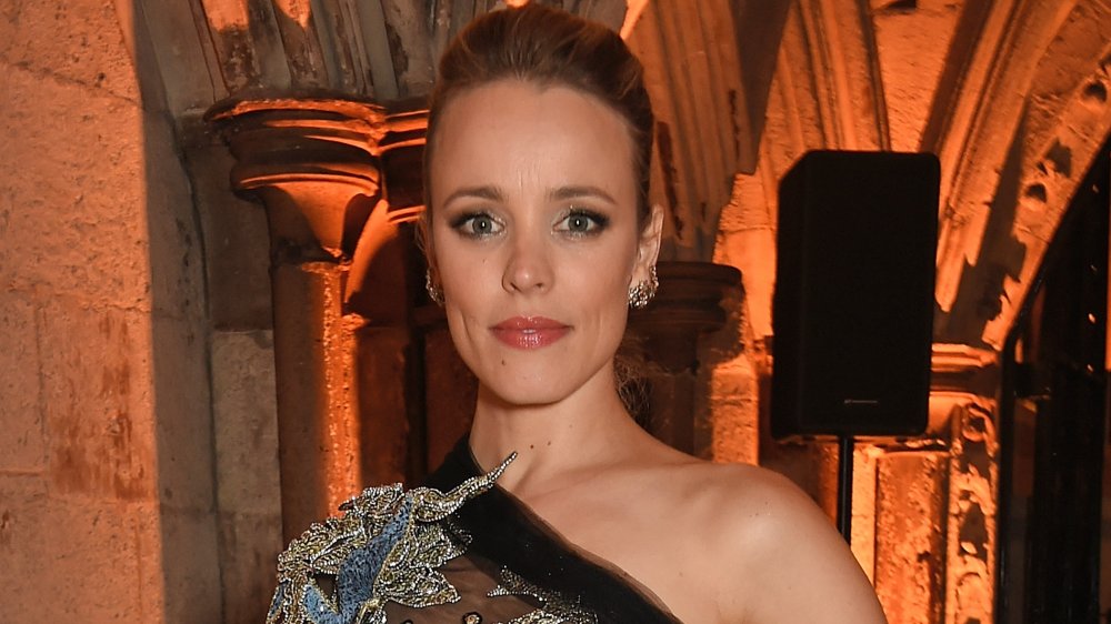 Rachel McAdams in a sparkly silver, blue, and black dress, posing with a neutral expression
