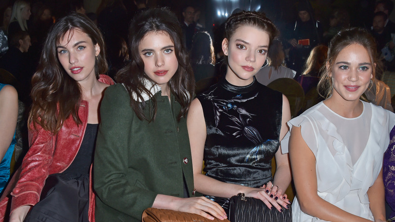 Rainey Qualley with celebrity friends, seated and posing