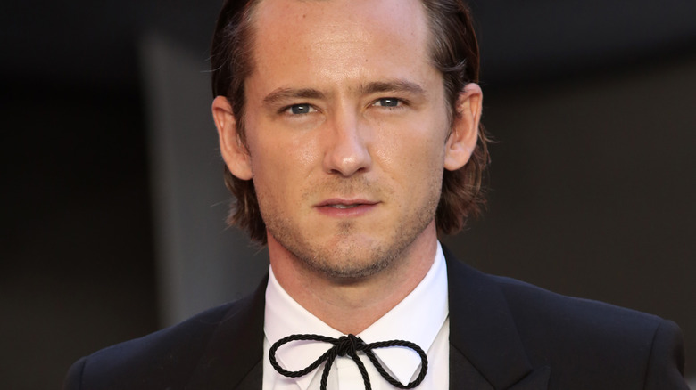 Lewis Pullman on red carpet, posing