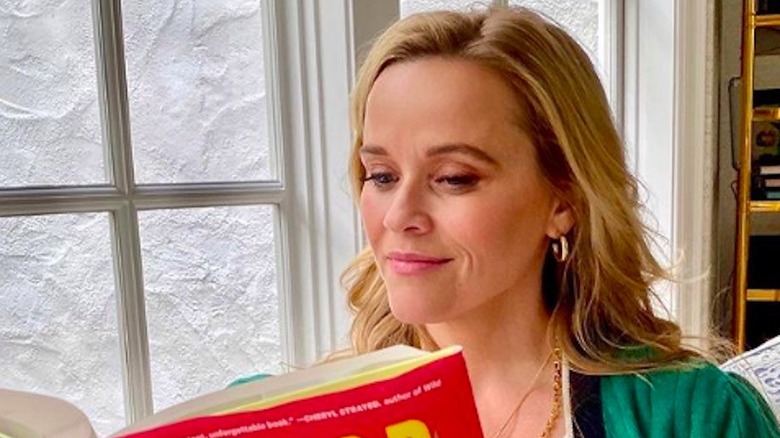 Reese Witherspoon reading a book