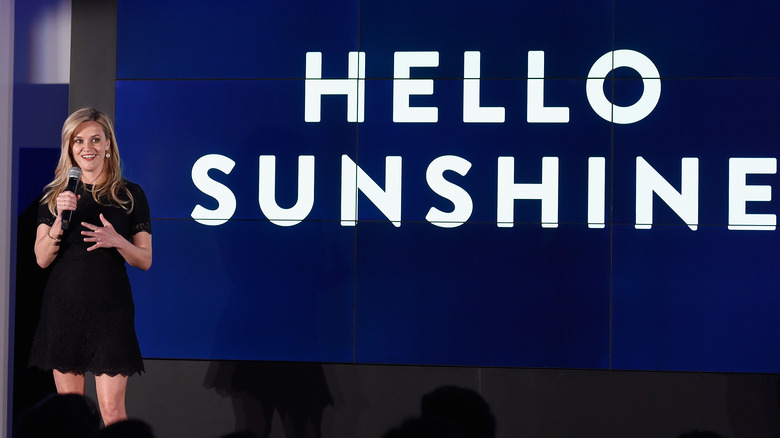 Reese Witherspoon speaking next to Hello Sunshine logo