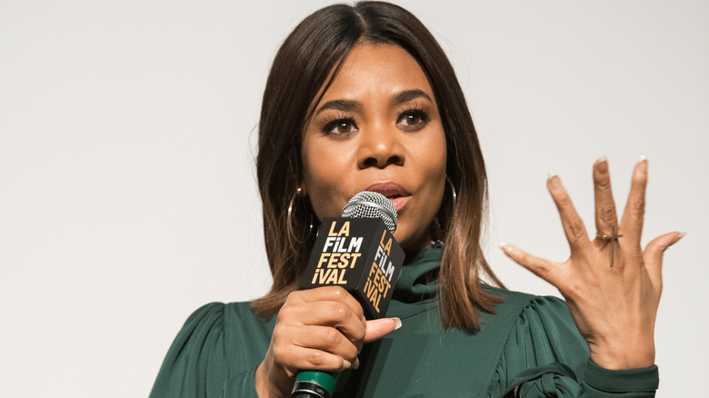 Regina Hall talking into a microphone