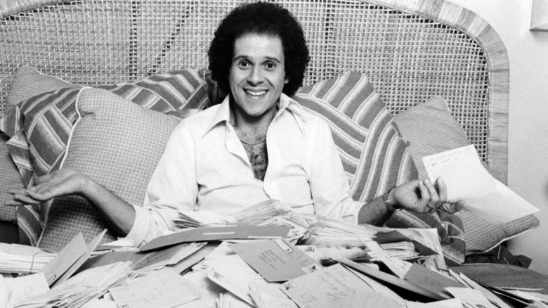 Richard Simmons holding letters