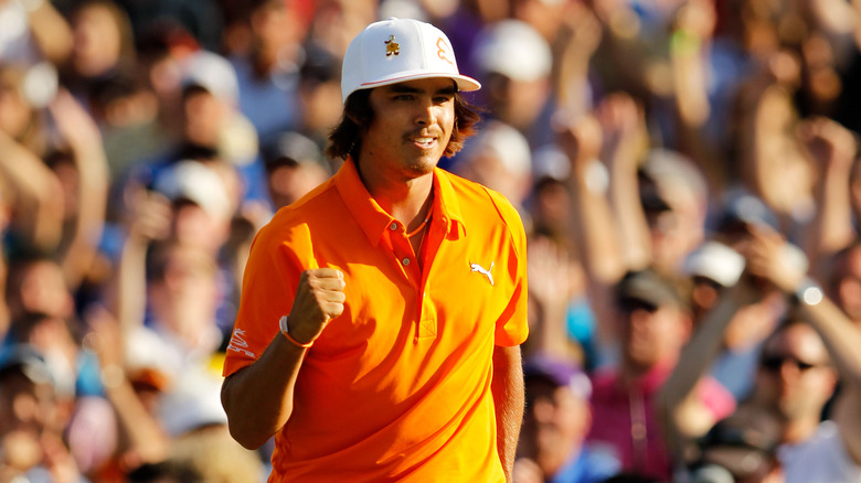 A crowd cheering behind Rickie Fowler