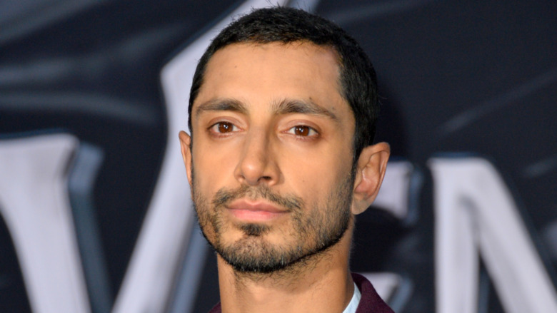 Riz Ahmed with a serious expression